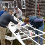 image of Friends working on calking and painting meetinghouse storm windows