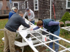 image of Friends working on calking and painting meetinghouse storm windows